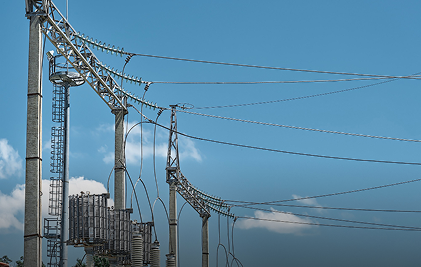 Power lines against clear blue sky, showcasing electrical infrastructure and technology.